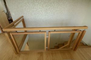 Tamme liimpuidust astmetega trepp. Piirdeks tammest 40x60 mm raamides 8 mm kirgas karastatud klaas, käsipuu 60x60 mm.